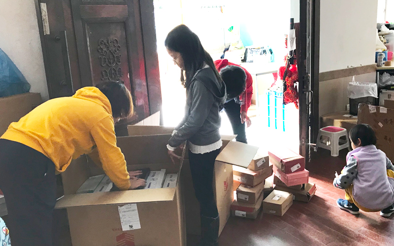 People unloading shoe donations