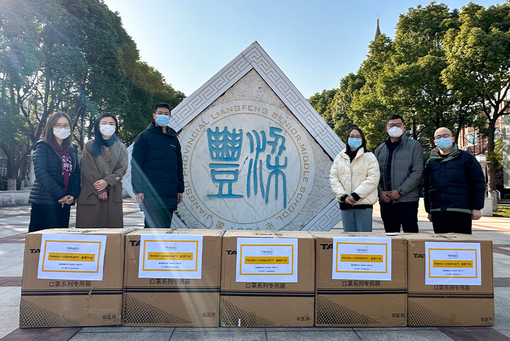 Trinseo employees standing in front of boxes of donated goods