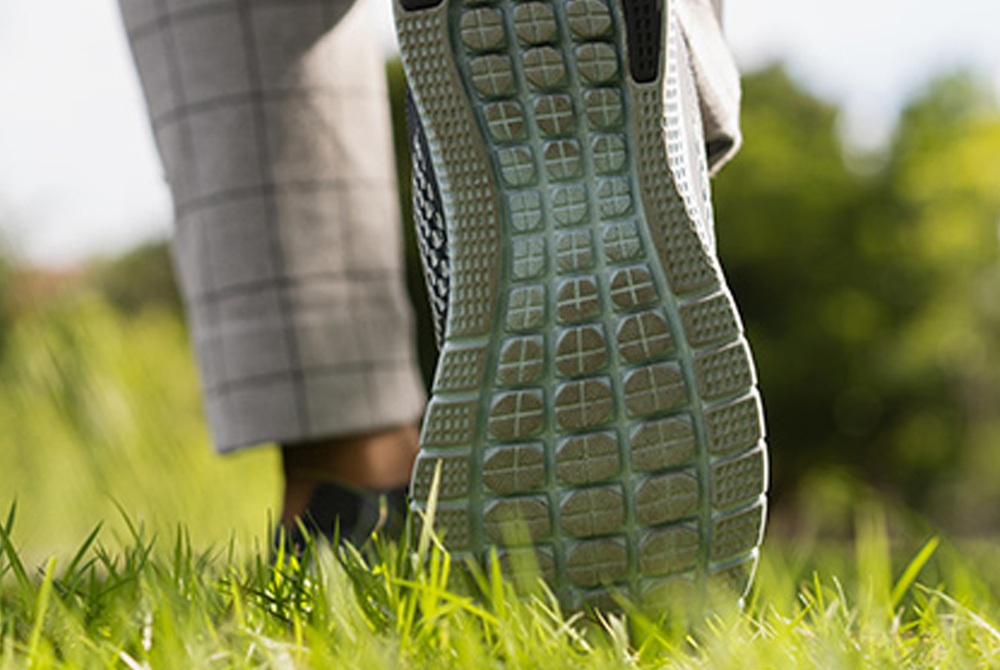 Close up of shoes walking in grass